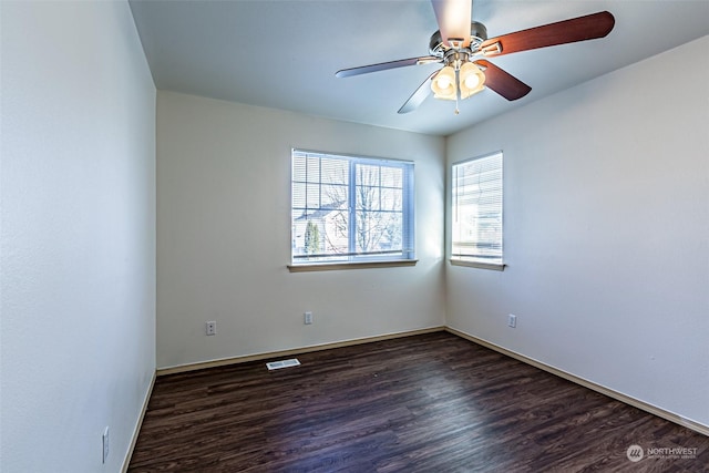 empty room with dark hardwood / wood-style floors and ceiling fan