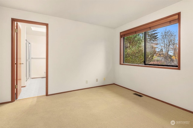 spare room with light colored carpet