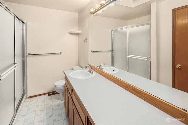 bathroom with toilet, vanity, and walk in shower