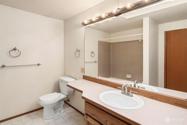 bathroom featuring walk in shower, vanity, and toilet