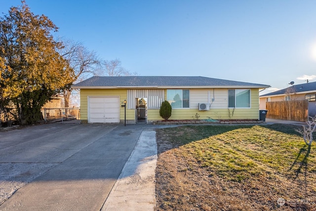 ranch-style house featuring a garage and a front lawn