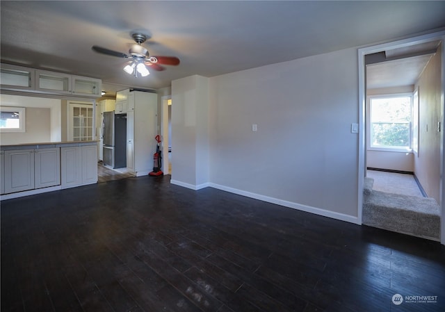 1506 Westport Rd, Aberdeen, WA 98520 - unfurnished living room with baseboards, a ceiling fan, and dark wood-style floors