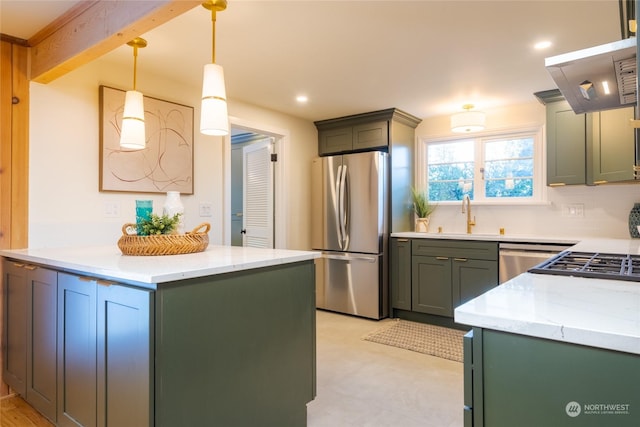 kitchen featuring sink, green cabinets, pendant lighting, stainless steel appliances, and light stone countertops