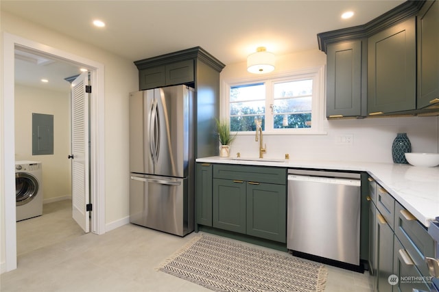 kitchen with washer / dryer, sink, decorative backsplash, electric panel, and stainless steel appliances