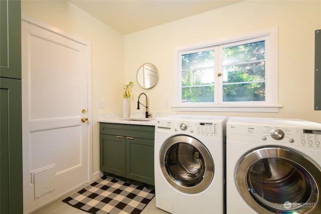 washroom with sink, washer and clothes dryer, and cabinets