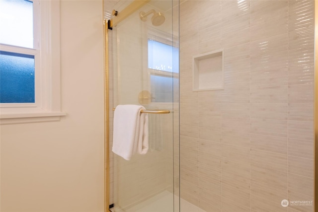 bathroom featuring a shower with door