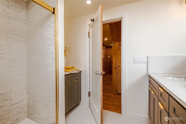 bathroom with vanity and tiled shower