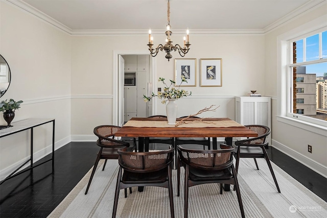 dining space featuring hardwood / wood-style flooring, ornamental molding, and a chandelier