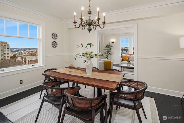 dining room with ornamental molding, dark hardwood / wood-style floors, and a chandelier