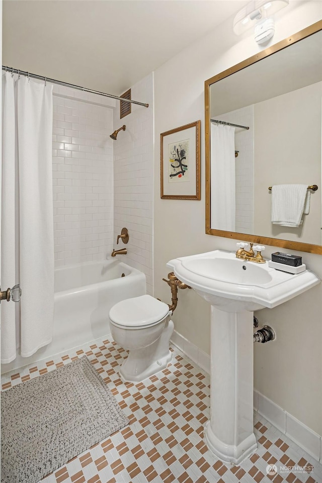 bathroom featuring shower / bath combination with curtain, tile patterned floors, and toilet