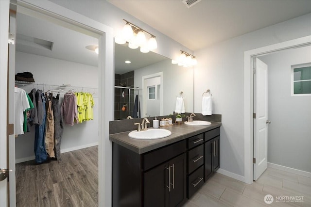 bathroom with walk in shower and vanity