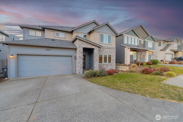 view of front of home with a garage and a lawn