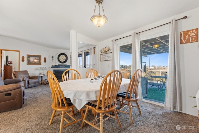 dining area featuring carpet floors and a fireplace