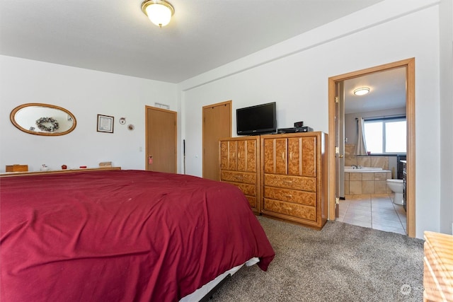 carpeted bedroom featuring lofted ceiling and connected bathroom