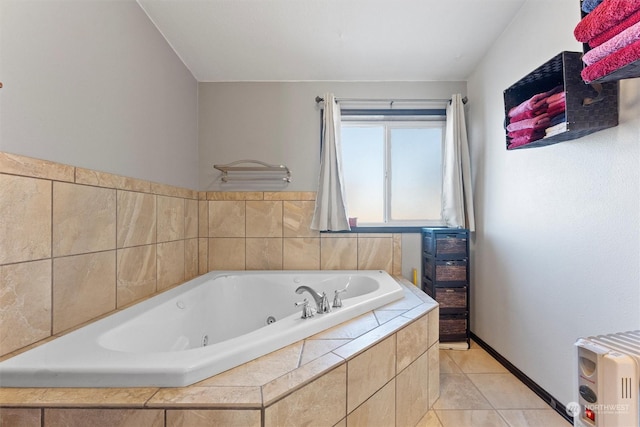 bathroom featuring tile patterned flooring and tiled bath