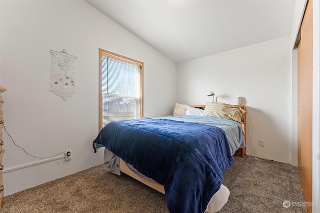 bedroom featuring vaulted ceiling and carpet floors