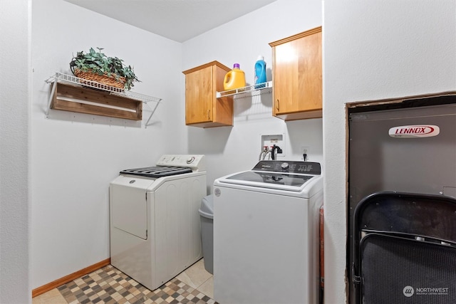 laundry room with cabinets and washer and clothes dryer