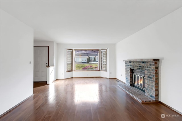 unfurnished living room with hardwood / wood-style flooring and a fireplace