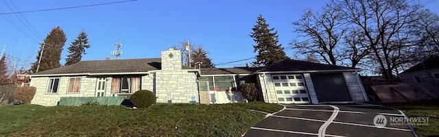 view of front of house with a garage and a front lawn