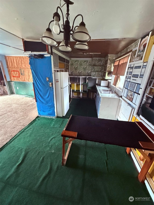 interior space with white fridge, sink, and dark carpet