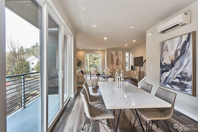 dining space featuring dark wood finished floors, a wall unit AC, recessed lighting, and baseboards