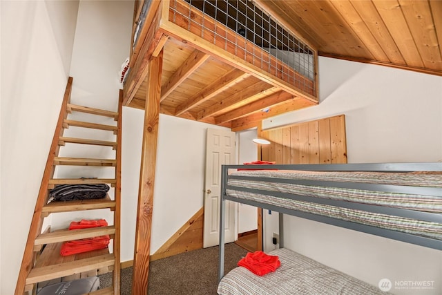 bedroom with dark carpet and wooden ceiling