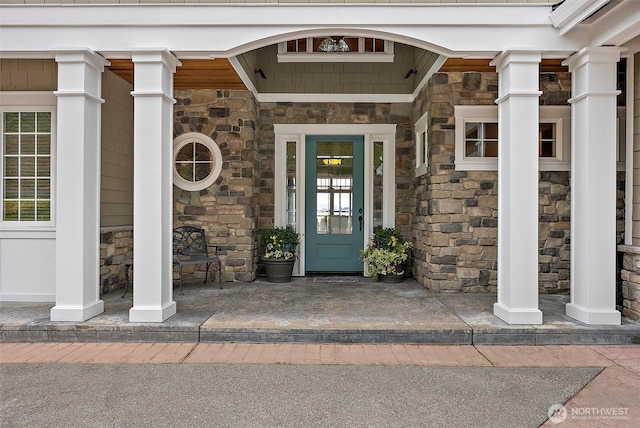 doorway to property with stone siding