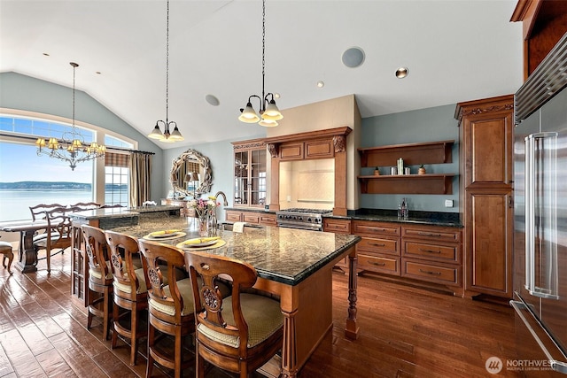 kitchen with brown cabinets, open shelves, a breakfast bar, and a sink