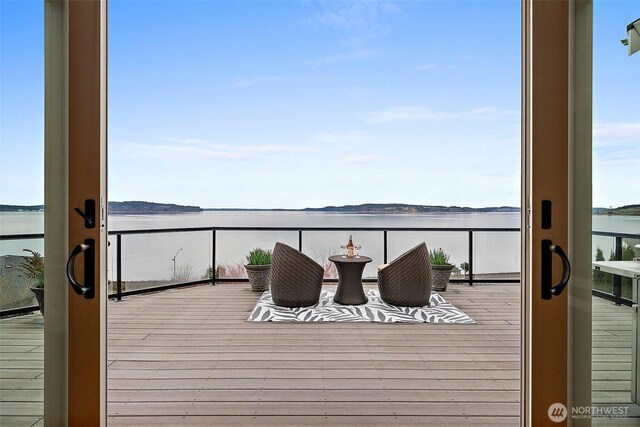 wooden deck featuring a water view