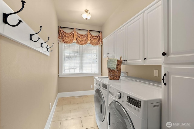 laundry area featuring visible vents, baseboards, washer and clothes dryer, light tile patterned floors, and cabinet space