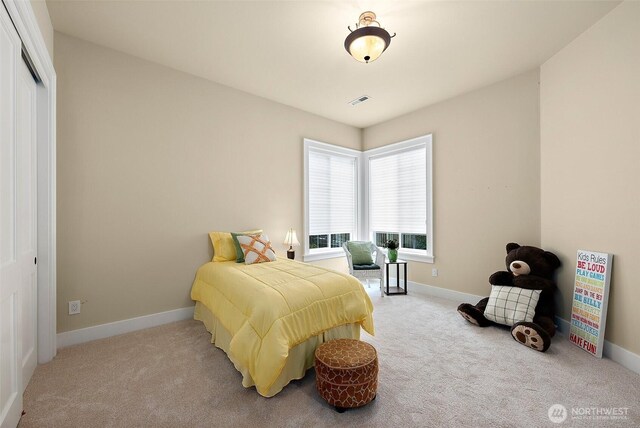 bedroom with baseboards, carpet floors, visible vents, and a closet