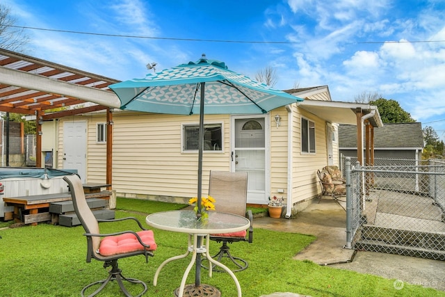 rear view of property featuring a pergola and a yard