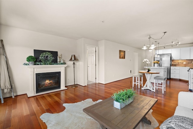 living room featuring wood-type flooring and a chandelier