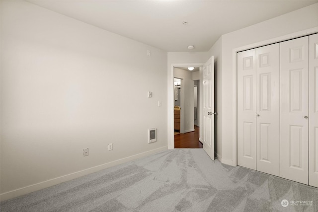 unfurnished bedroom featuring carpet floors and a closet