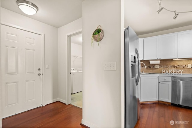 kitchen featuring sink, appliances with stainless steel finishes, tasteful backsplash, white cabinets, and dark hardwood / wood-style flooring