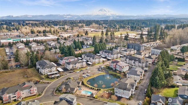 birds eye view of property with a water and mountain view