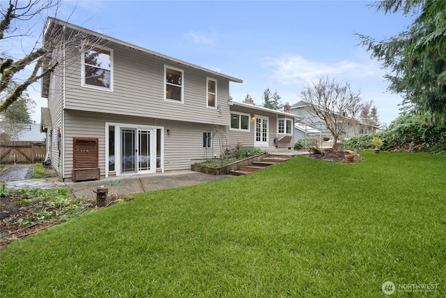 back of house with a yard and a patio area