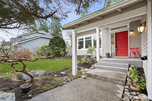 doorway to property featuring a lawn