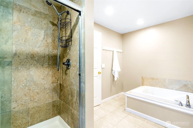 bathroom featuring tile patterned flooring and shower with separate bathtub