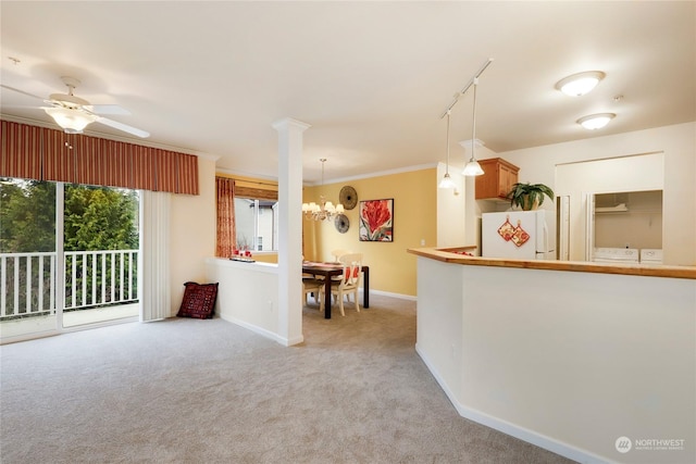 kitchen featuring light colored carpet, ornamental molding, decorative light fixtures, and white fridge