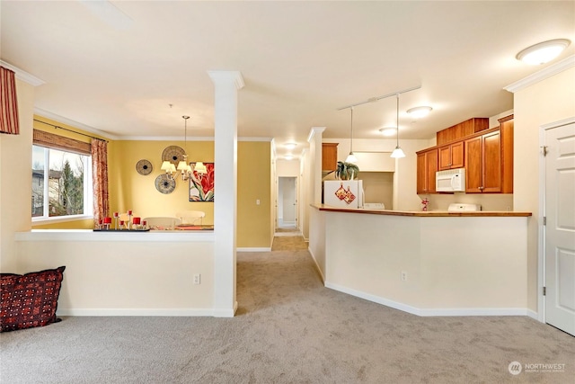 kitchen with light colored carpet, hanging light fixtures, ornamental molding, kitchen peninsula, and white appliances