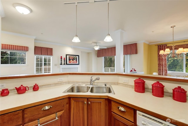 kitchen featuring a healthy amount of sunlight, decorative light fixtures, dishwasher, and sink