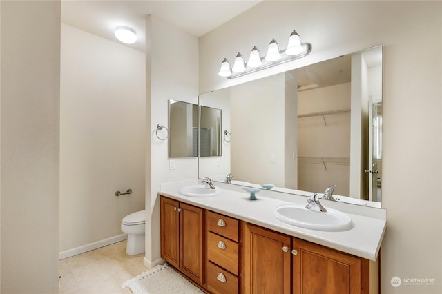 bathroom featuring vanity, toilet, and tile patterned flooring