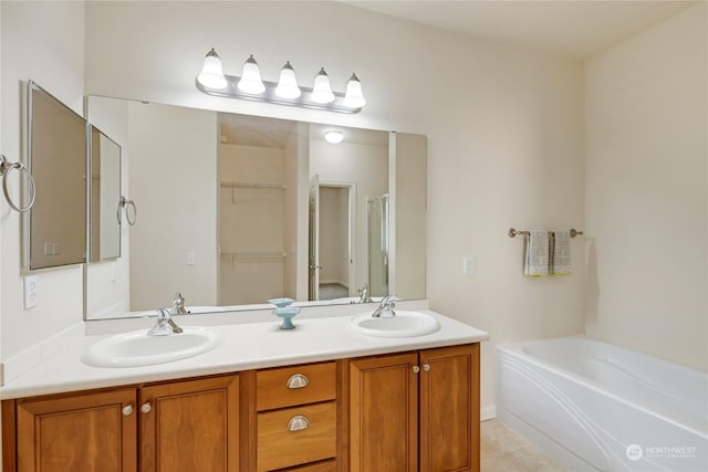 bathroom with vanity, tile patterned floors, and a bathtub