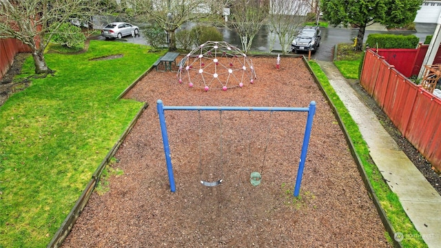 surrounding community with a yard and a playground