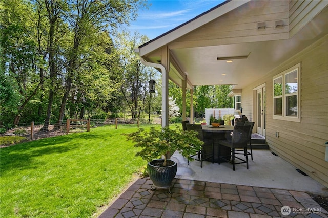 view of patio / terrace featuring fence, outdoor dining space, and french doors