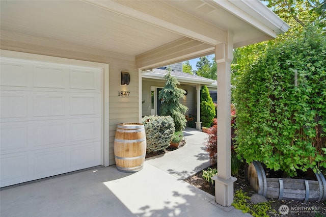 view of patio with driveway and an attached garage