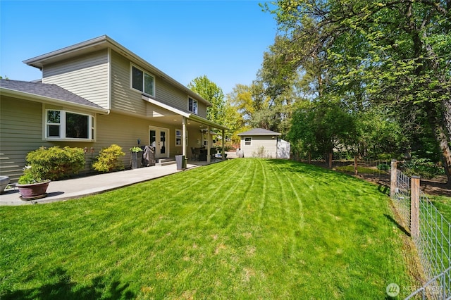 rear view of property featuring a patio, a yard, french doors, and fence