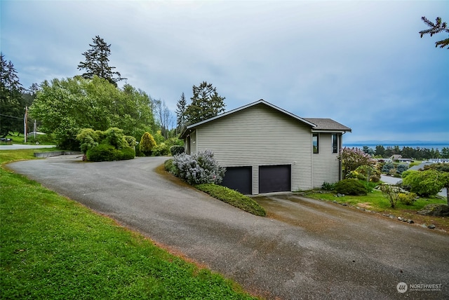 view of side of home with a garage