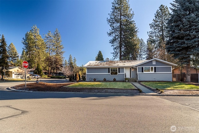 ranch-style home with a front lawn